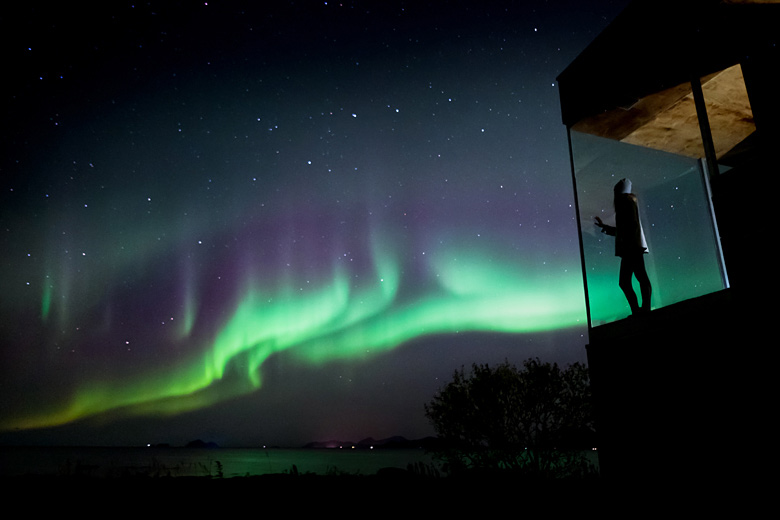 Watching the aurora from the warmth of a cabin